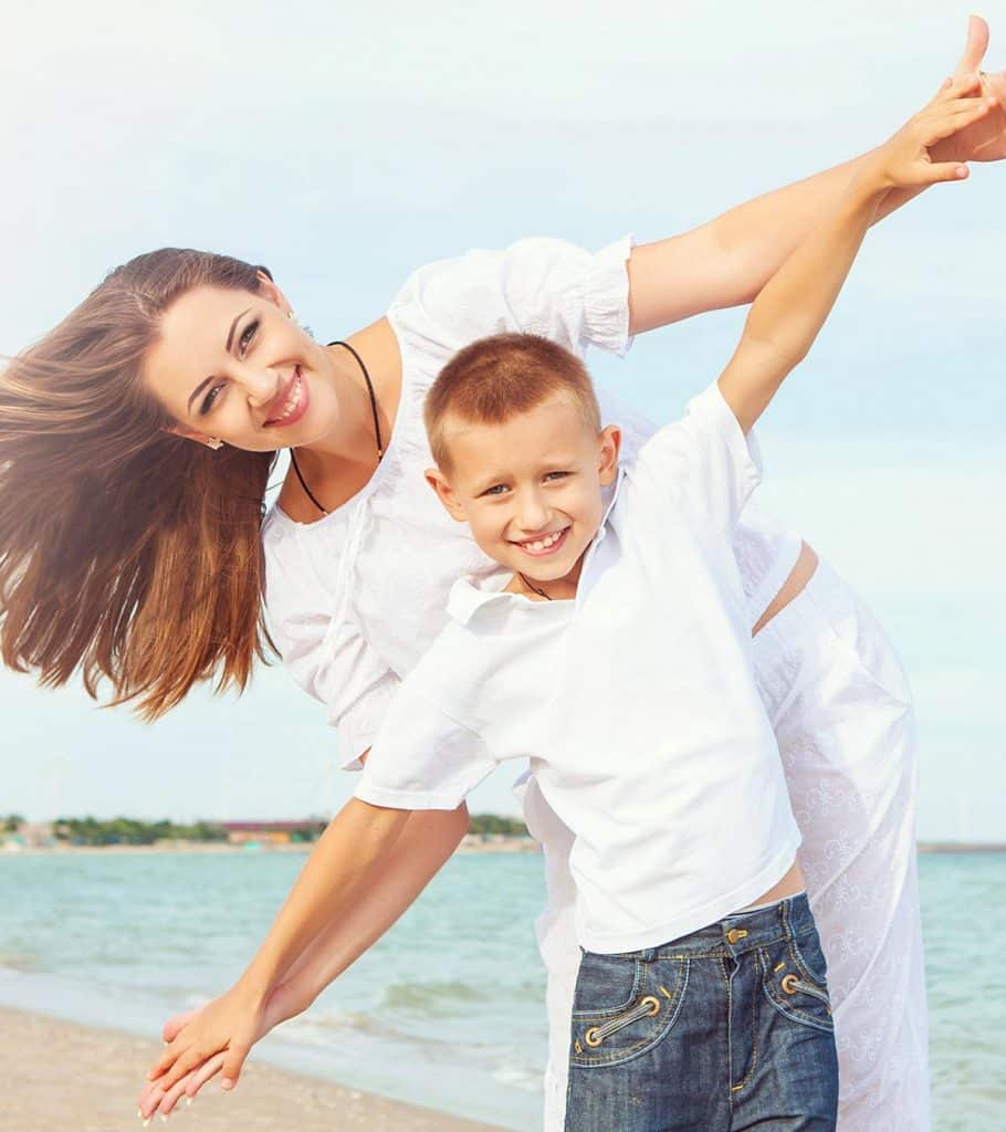 mom and son having playful time at the beach side