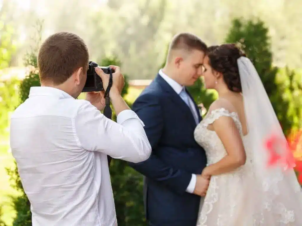 a photographer taking picture of a couple