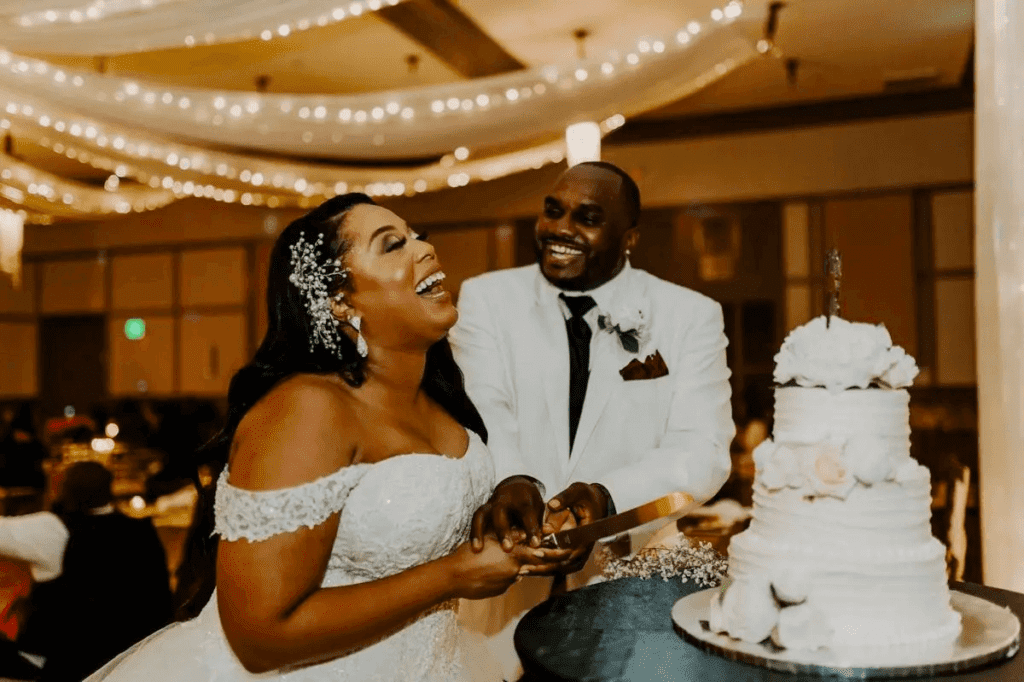 bride and groom giggling after cutting cake