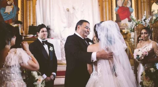 candid wedding photo bride talking to her dad guests gathered around