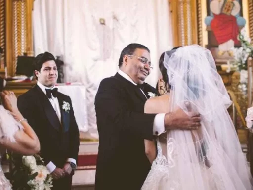 candid wedding photo bride talking to her dad guests gathered around