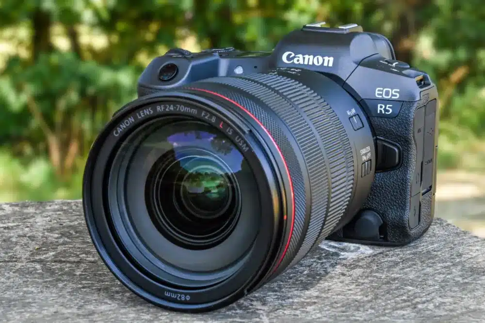 canon camera in black color placed on a surface