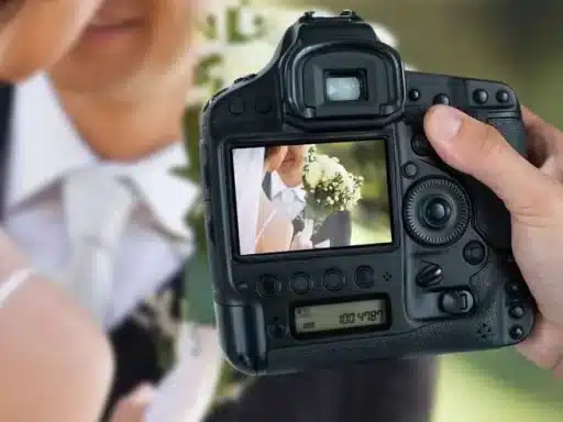 someone taking picture of bride and groom in a camera