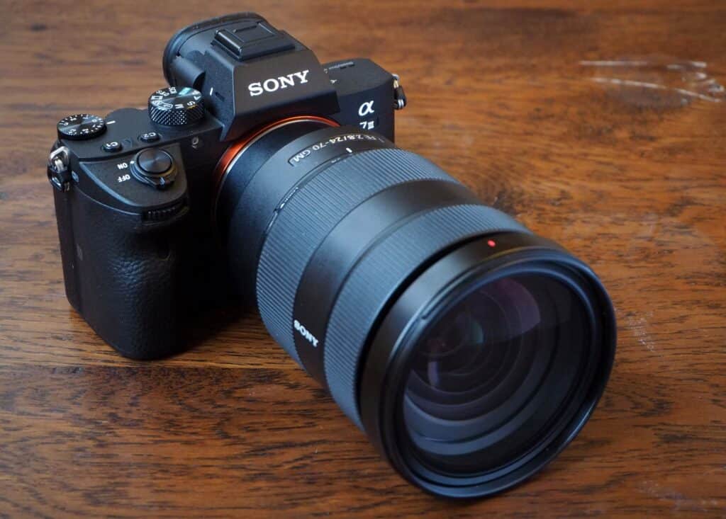 sony camera A in black color placed on wooden surface