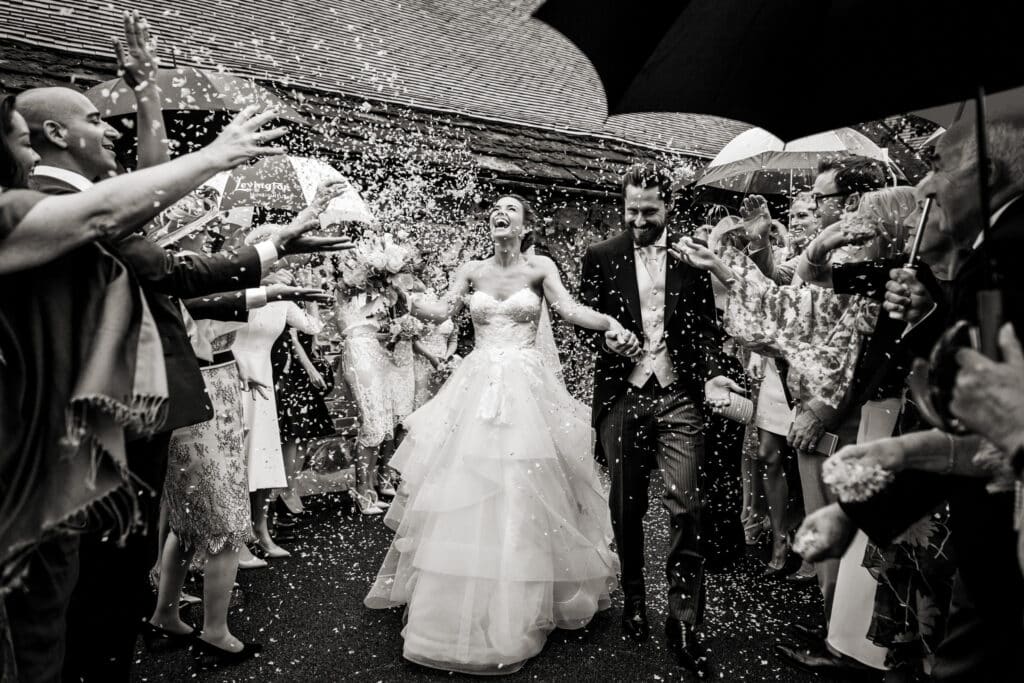 unstaged photo of bride and groom celebrating in the presence of guests