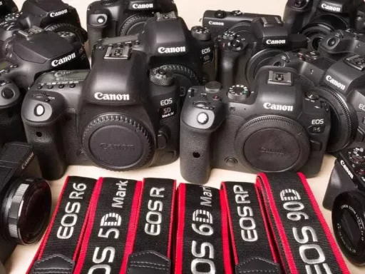 a variety of canon camera placed on a surface