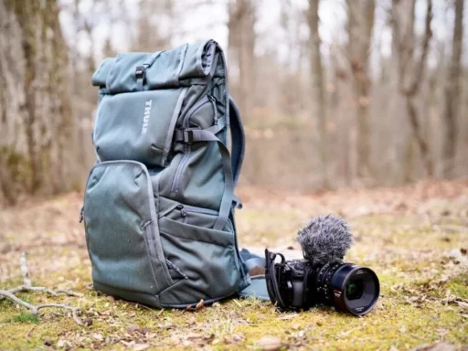 a backpack and camera placed on ground