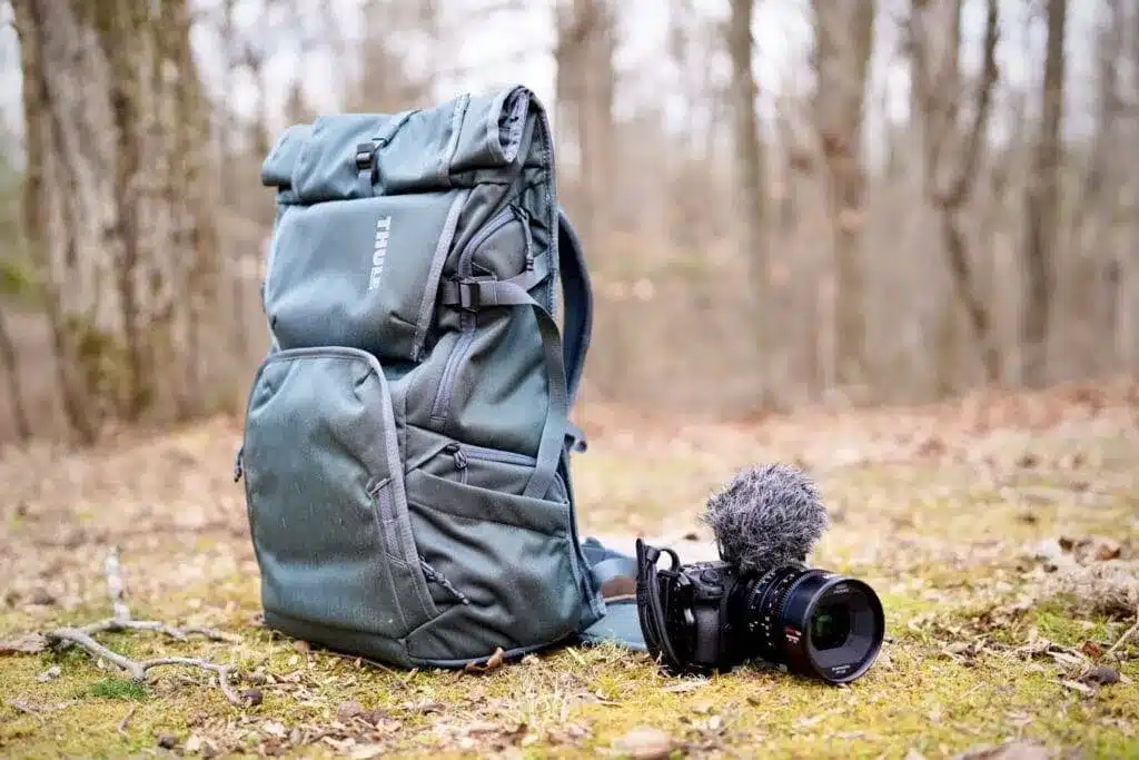 a backpack and camera placed on ground