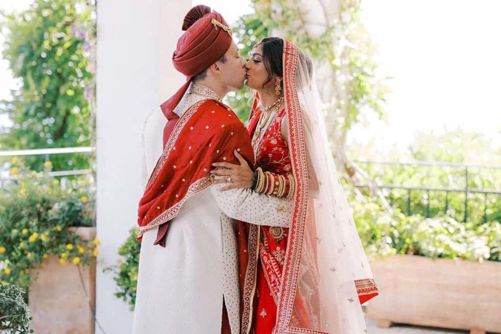 bride and groom dressed up and kissing