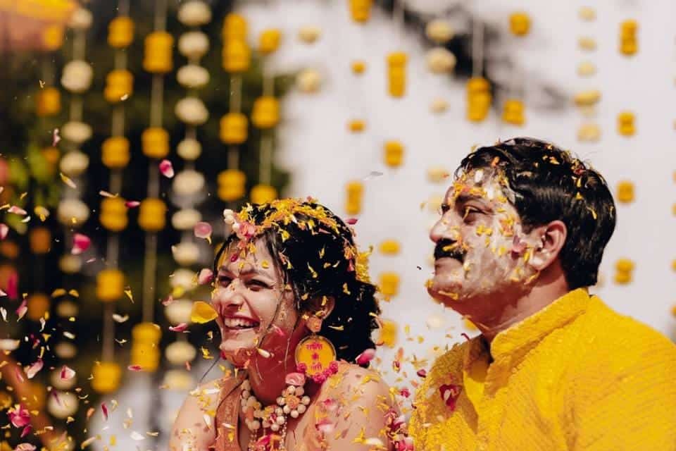 bride and groom with ubtan faces posing and smiling