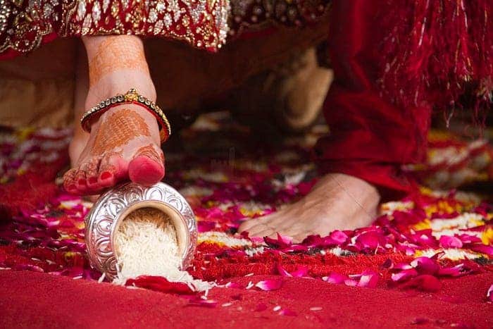 brides foot kicking rice bowl as ritual