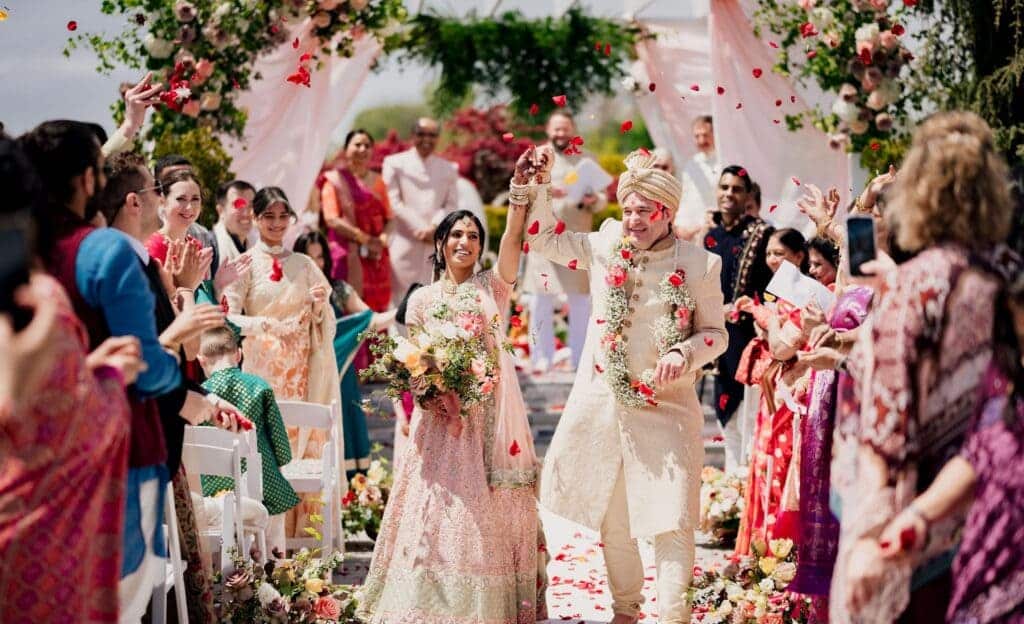 candid picture of bride and groom celebrating in front of guests