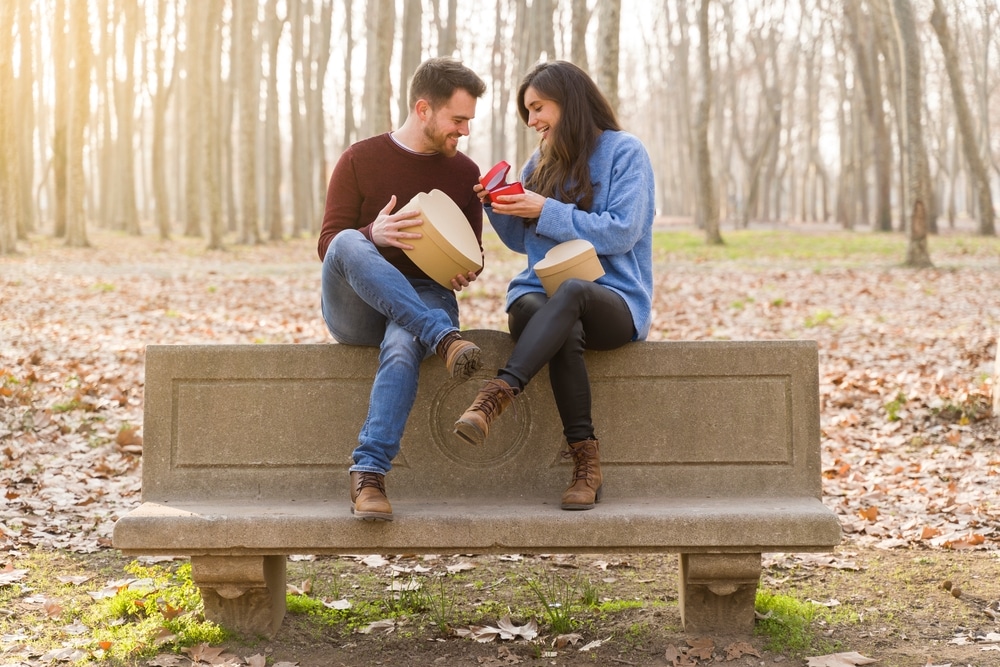 Young Couple Celebrating Valentine's Day Giving Each Other A Gift