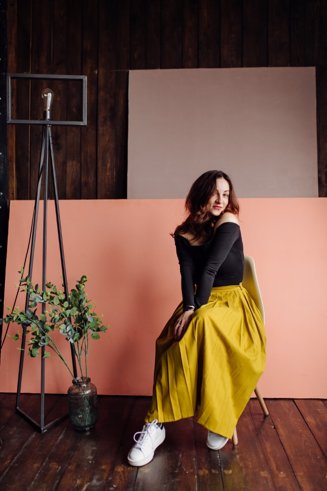 Portrait of a stunning fashionable woman sitting in a chair
