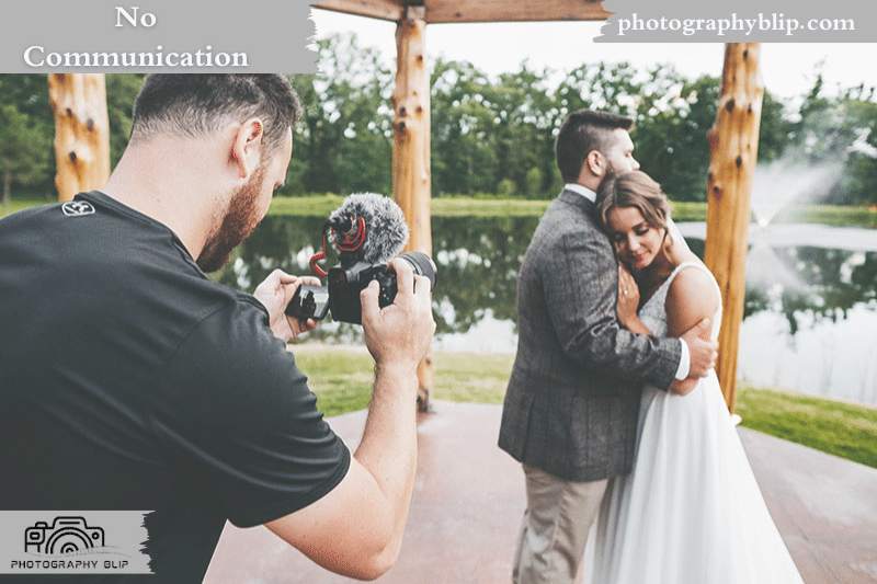 bride and groom hugging each other, photographer taking picture