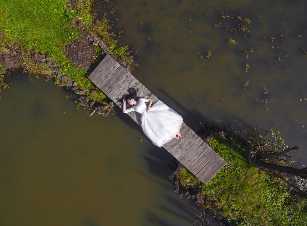 The Bride Is Lying On A Wooden Bridge Barefoot Top