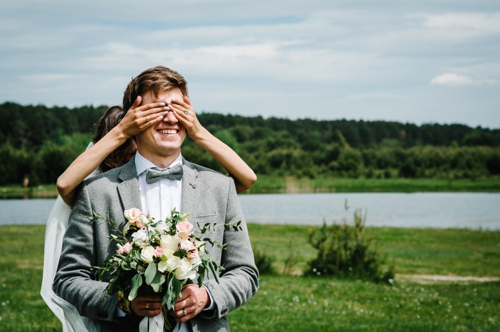 The first meeting is newlyweds on a green field outdoors