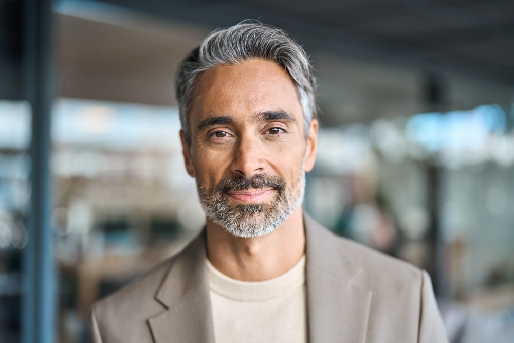 Close up headshot portrait of happy middle aged older professional business man