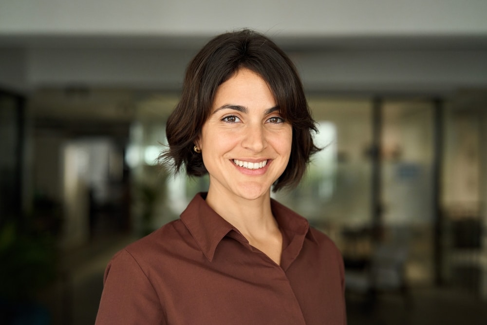 Headshot close up face portrait of young happy smiling woman