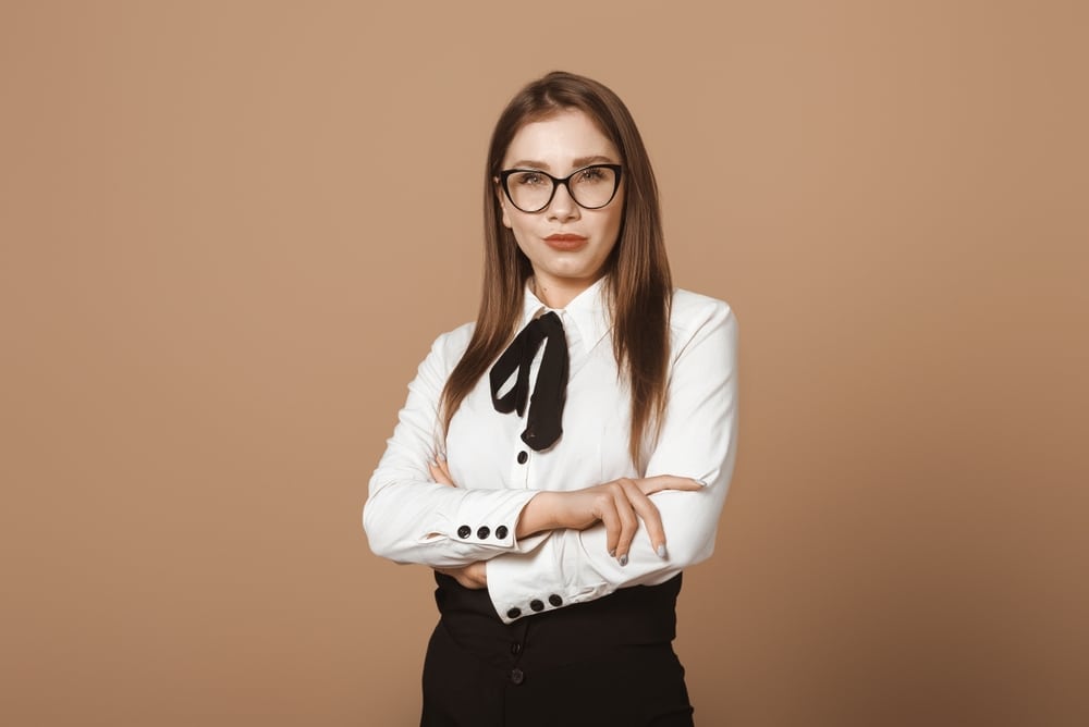 Confident Woman in Power Pose. Attractive Lady Standing with Crossed Arms on Chest.