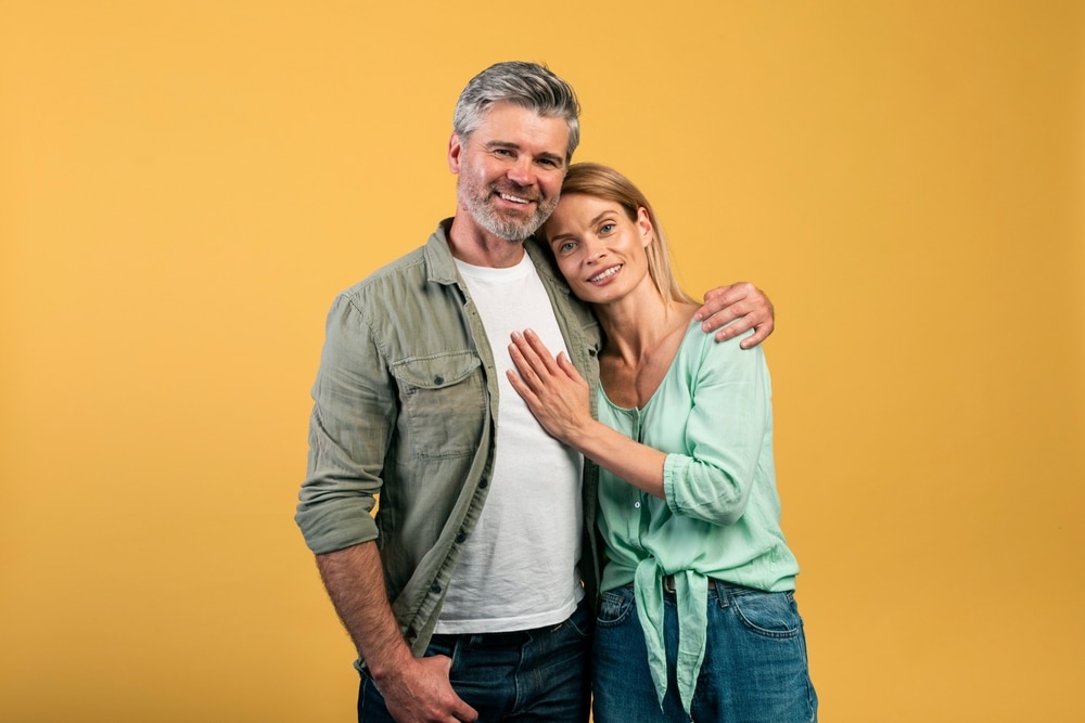 Portrait Of Happy Mature Couple Hugging And Posing At Camera