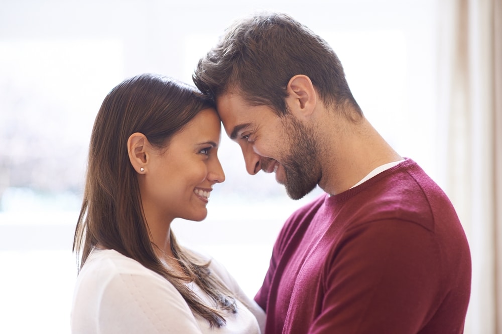 happy couple with forehead touch pose