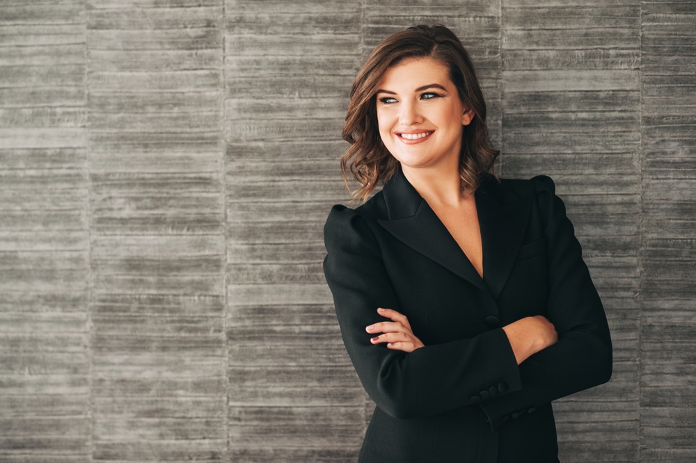 headshot pose of a woman wearing a black suit